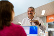 Photo: girl and senior man returning book in library girl and senior man returning book in library