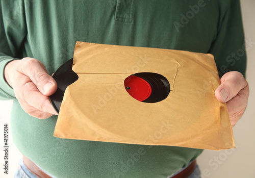 Photo: removing old vinyl record from sleeve removing old vinyl record from sleeve