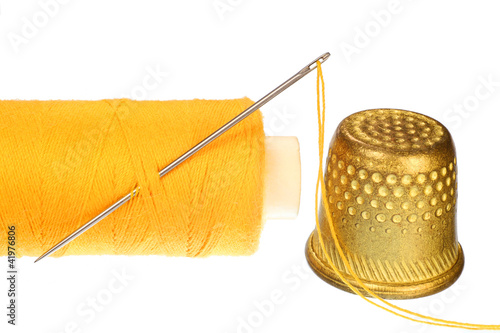 Photo: Needle, Thimble and a Spool of Thread. Needle, Thimble and a Spool of Thread.
