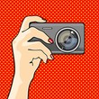 Illustration of a hand holding a photo camera