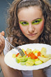 Photo: Closeup portrait of an attractive young woman eating Closeup portrait of an attractive young woman eating
