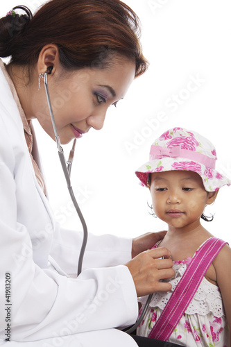 Photo: Doctor examining child with stethoscope Doctor examining child with stethoscope