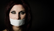 Woman with duct tape over mouth