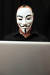 member of Anonymous hacker group at computer member of Anonymous hacker group at computer
