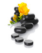 Spa stones and yellow flower isolated on white