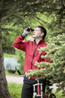 The man with a bicycle looks in monocular