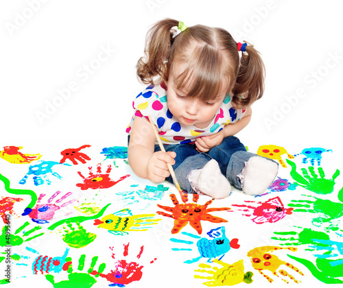 Photo: little girl drawing a poster paints to protect the environment little girl drawing a poster paints to protect the environment