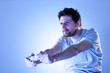 Concentrated Man Playing Videogames with Gamepad