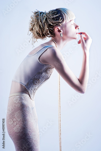 Photo: beautiful skinny blonde fashion stands in profile with his eyes beautiful skinny blonde fashion stands in profile with his eyes