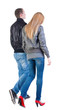 Back view of walking young couple