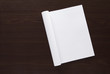Open folded magazine on wooden background