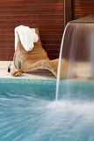 swimming pool falling water and sunbad