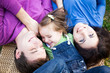 Portrait of family lying outdoors