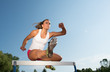 Photo: Professional female hurdler in action Professional female hurdler in action