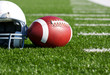 Football and Helmet on the Field