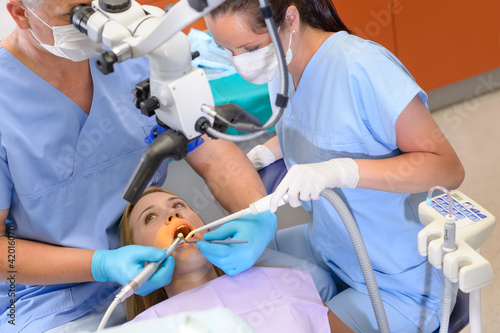 Photo: Dentist operation patient through microscope Dentist operation patient through microscope
