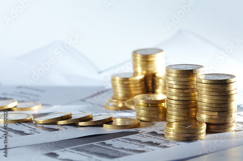 Photo: Business diagram on financial report with coins Business diagram on financial report with coins
