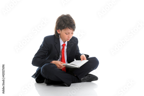 Photo: little boy reading a book little boy reading a book