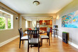 Large bright luxury dining wiith with kitchen in the back.