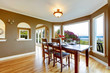 Photo: Dining room with brown walls and wood table. Dining room with brown walls and wood table.