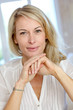 Portrait of blond mature woman relaxing in sofa
