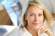 Portrait of blond mature woman relaxing in sofa