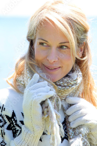 Photo: Portrait of middle-aged woman in winter at the beach Portrait of middle-aged woman in winter at the beach