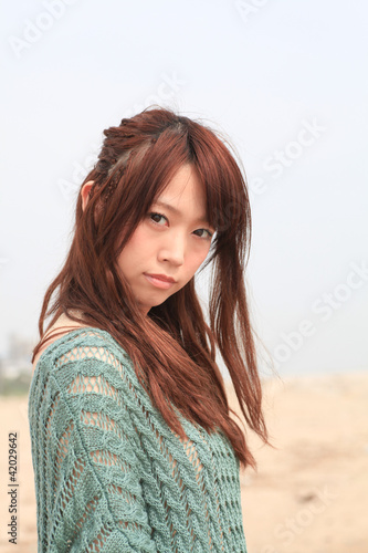 Photo: A young woman at beach / Long hair A young woman at beach / Long hair