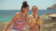 Two female friends  taking photo with cellphone