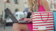 Female hands working on laptop in the city, steadicam shot