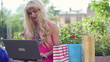 Attractive woman working on laptop in the city, steadicam shot