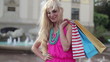Happy woman with shoping bags in the city, steadicam shot