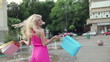 Video: Happy woman with shoping bags in city, slow motion Happy woman with shoping bags in city, slow motion