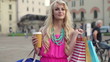 Happy woman with shoping bags in the city, slow motion