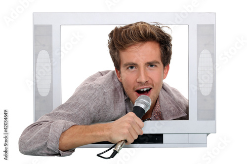 Photo: Man singing inside television Man singing inside television