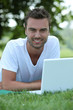 Man using laptop in park