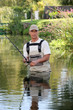 Fisherman stuck in river