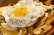 Fried egg with ground pepper on crispy fried potato