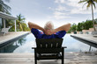Older man relaxing by a luxurious pool