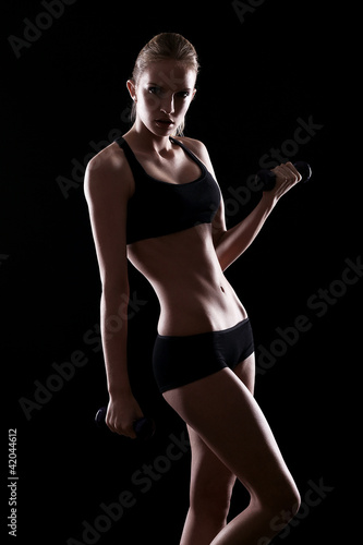 Photo: Sexy woman doing exercises with dumbells Sexy woman doing exercises with dumbells