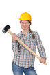 Happy handywoman holding a hammer