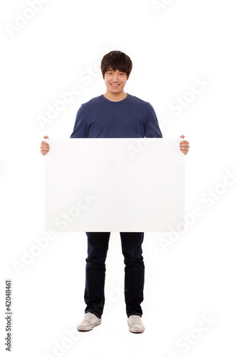 Photo: Young man holding a blank panel Young man holding a blank panel