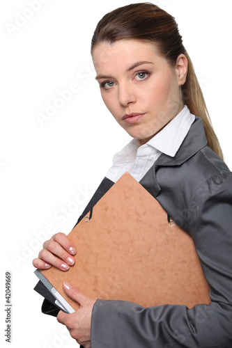 Photo: Young businesswoman holding folder Young businesswoman holding folder