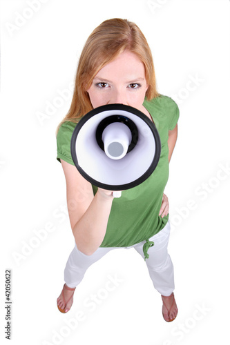 Photo: Ginger haired girl speaking into megaphone Ginger haired girl speaking into megaphone