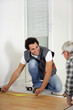 Man measuring flooring