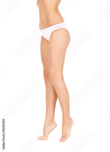 Photo: female legs in white bikini panties female legs in white bikini panties