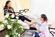 Woman wearing white coat practices chiropody taking care of feet