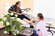 Woman wearing white coat practices chiropody taking care of feet