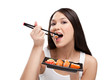 Attractive woman eating sushi