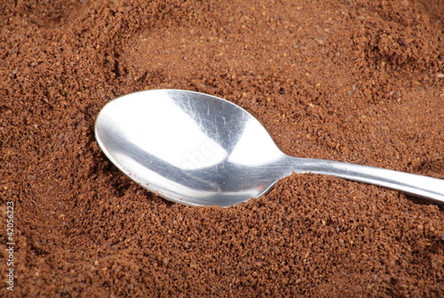 Photo: milled coffee and one teaspoon milled coffee and one teaspoon